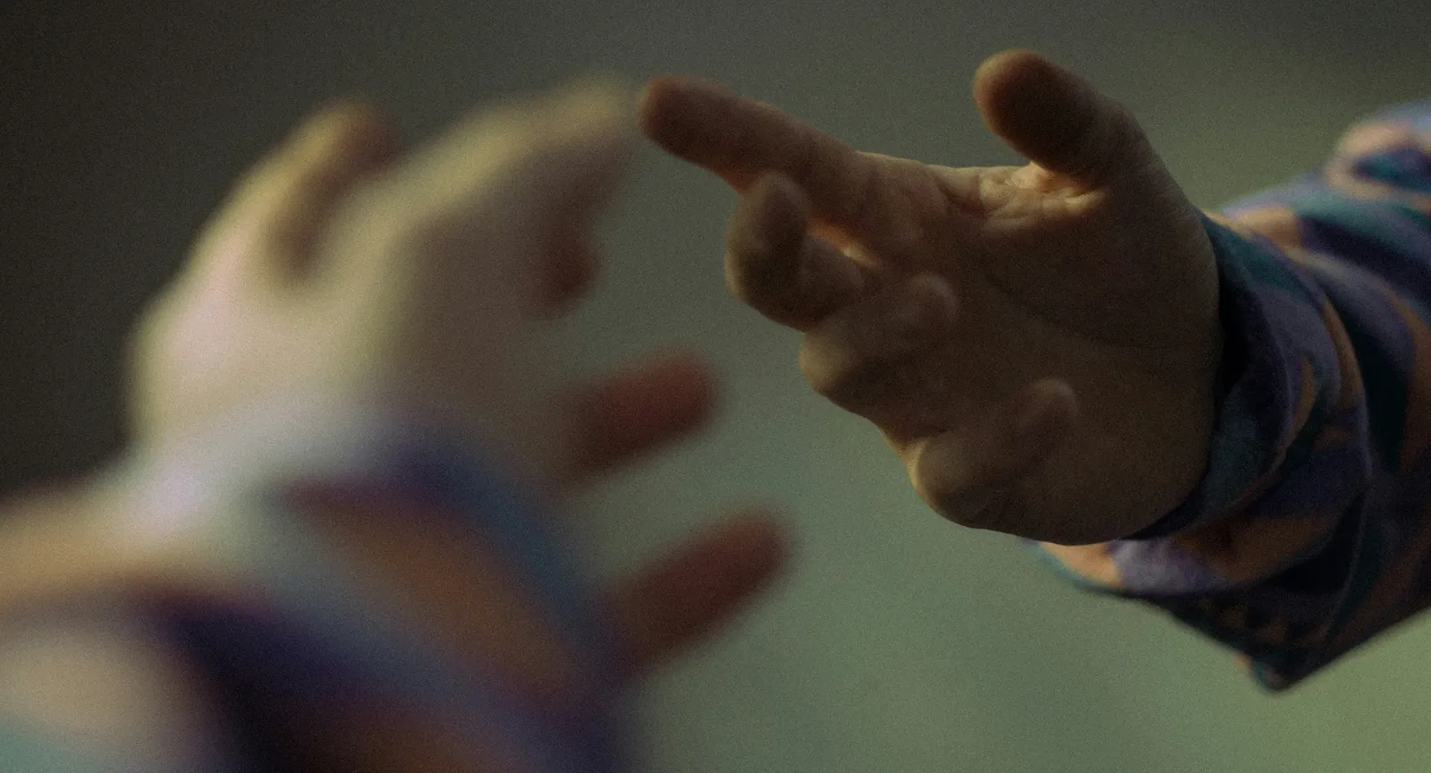 Two hands reaching toward each other