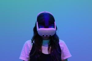 Person wearing a virtual reality headset in front of a green-blue spectrum background