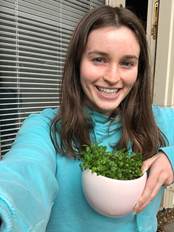 Claire Netemeyer holding a plant