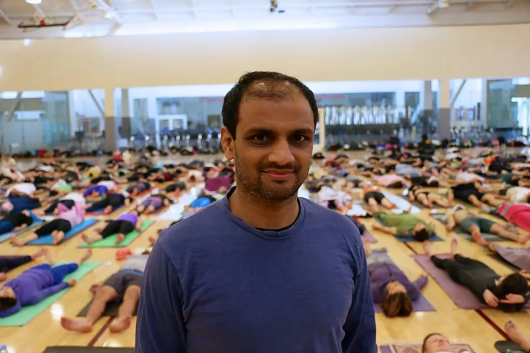 Sharat Jois in front of a class at UVA where the studies are doing Shiva pose