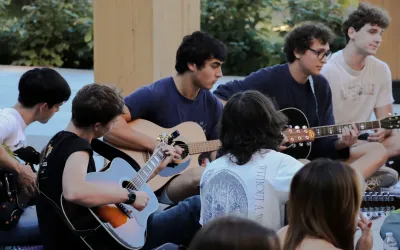 Students playing guitars together in the Contemplative Commons’ Gingko Garden