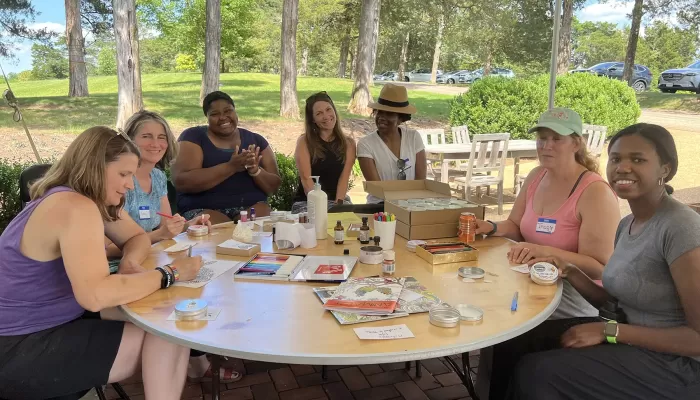 A group of CSP Educators sitting around a table outside