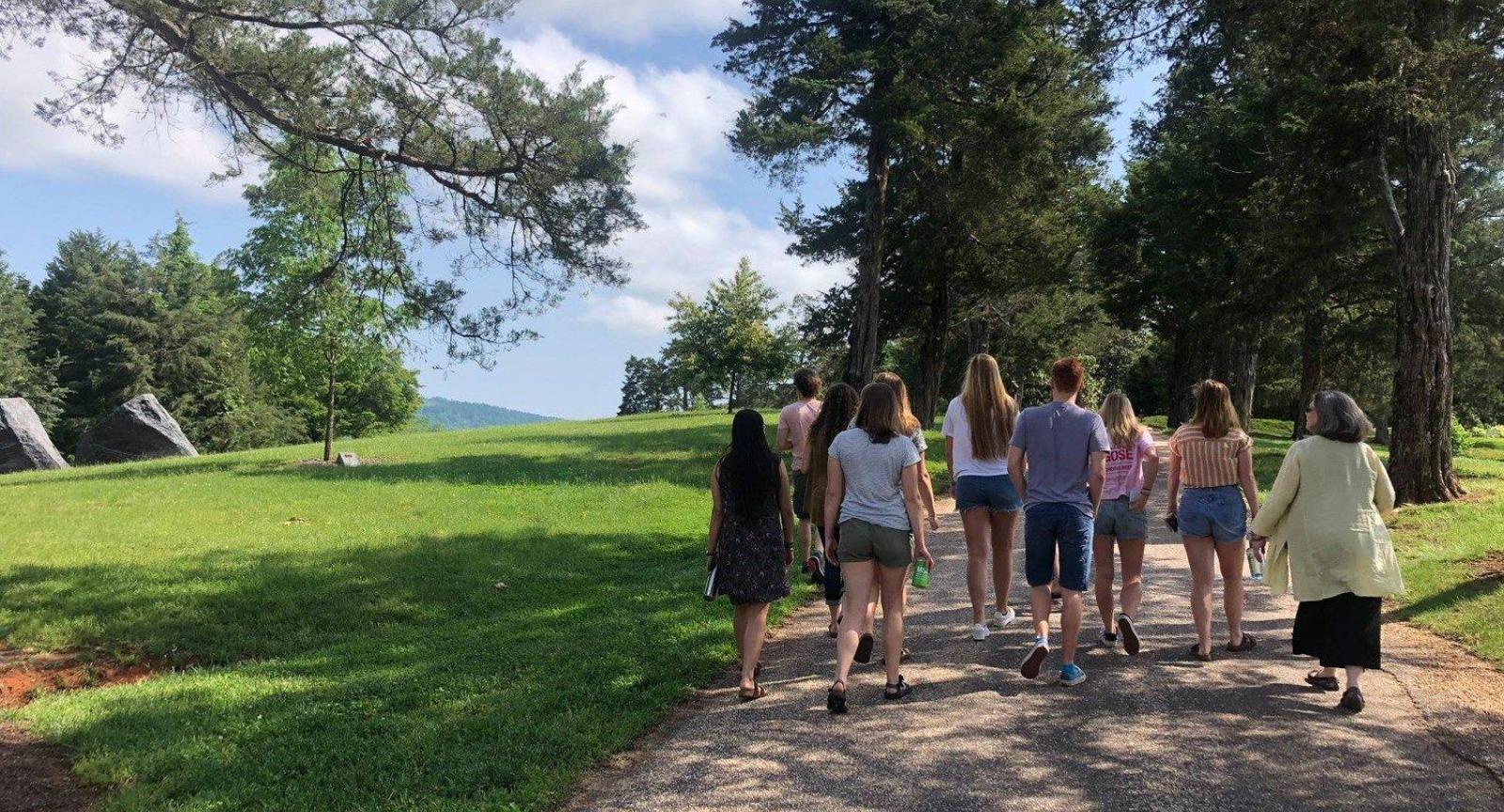 A group of students walking down a gravel road at Morven Farm