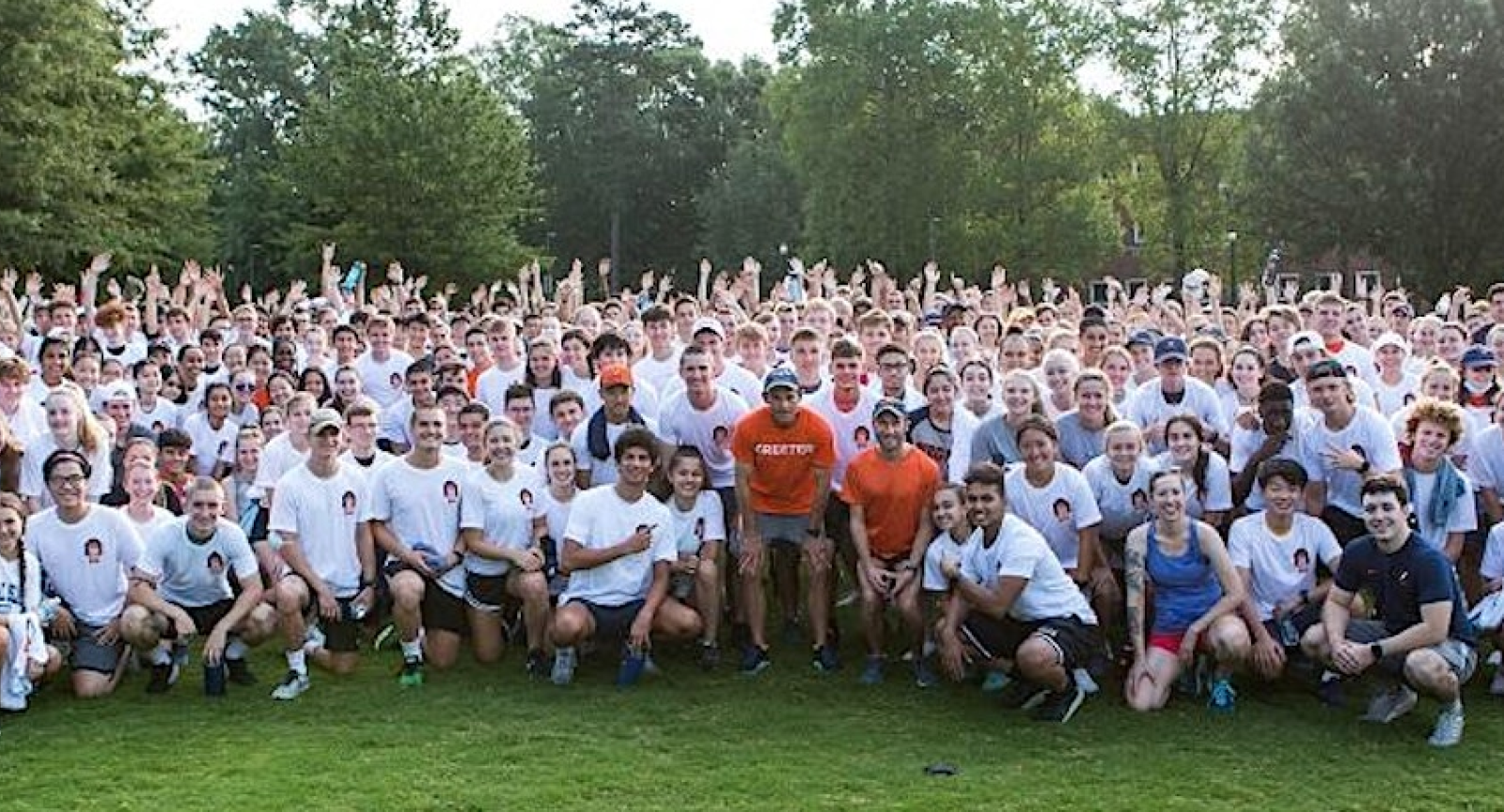 A large group of UVA students pose with President Jim Ryan before a Run with Jim event