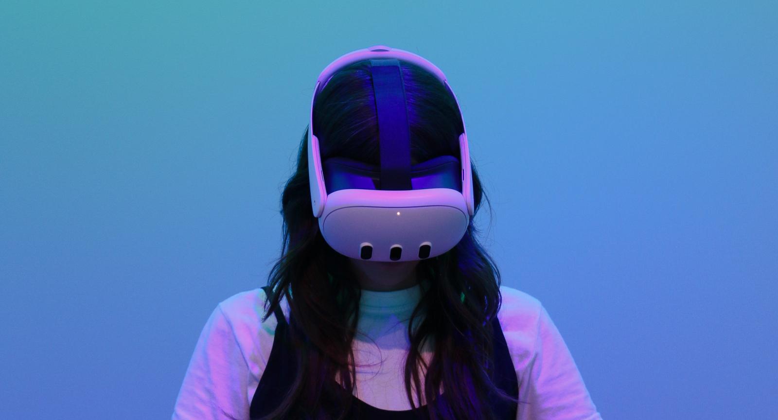 Person wearing a virtual reality headset in front of a green-blue spectrum background