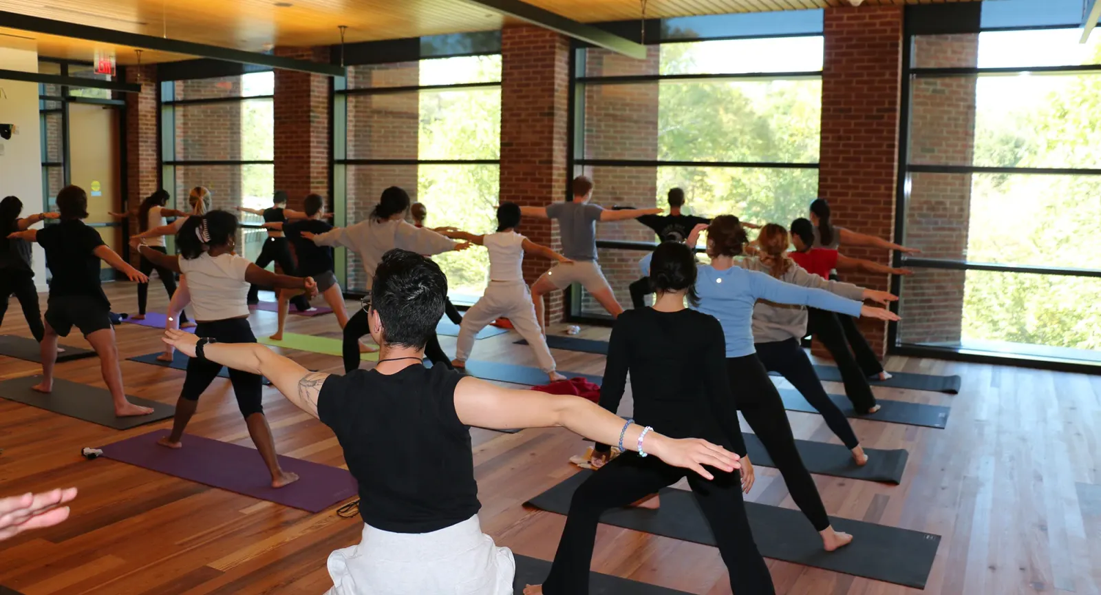 A yoga class in the Contemplative Commons, students in the Hero Pose