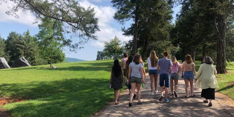 A group of students walking down a gravel road at Morven Farm