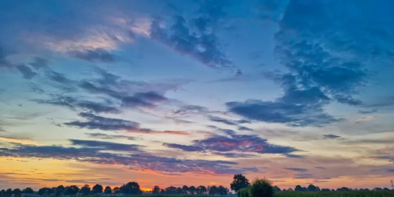 Dawn sky looking down a country road during the summer