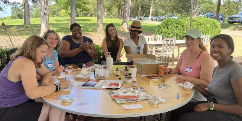 A group of CSP Educators sitting around a table outside