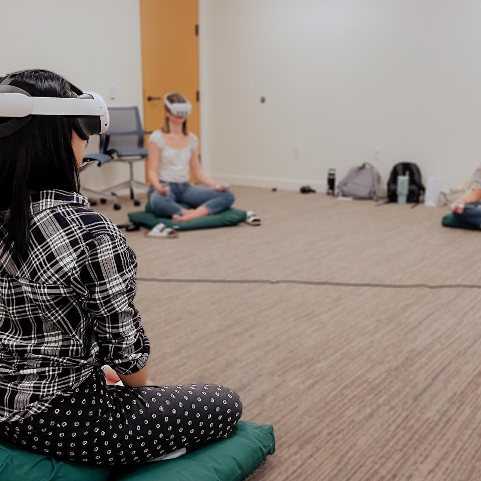Study participants sitting on pillows and using VR