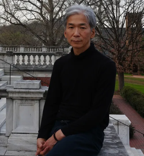 Seunghun Lee sitting by the Rotunda at the University of Virginia