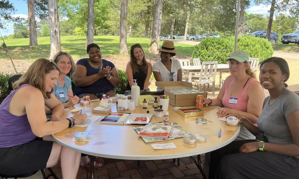 A group of CSP Educators sitting around a table outside