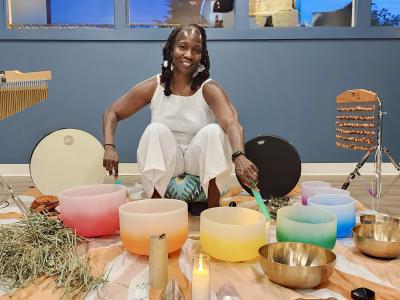 Selena Cozart surrounded by sound bath bowls.
