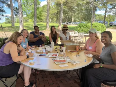 A group of CSP Educators sitting around a table outside