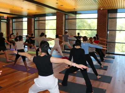 A yoga class in the Contemplative Commons, students in the Hero Pose