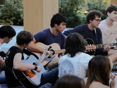 Students playing guitars together in the Contemplative Commons’ Gingko Garden